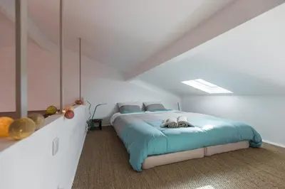 a bedroom with a large bed with blue sheets at Le Château - THE MOST BEAUTIFUL SIGHT IN OLD TOWN, private terrace in Nice