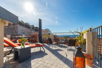 a patio with a table and chairs on a balcony at Le Château - THE MOST BEAUTIFUL SIGHT IN OLD TOWN, private terrace in Nice