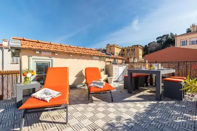 a patio with orange chairs and a table on a roof at Le Château - THE MOST BEAUTIFUL SIGHT IN OLD TOWN, private terrace in Nice