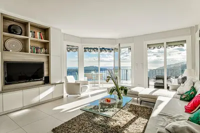 a living room with a couch and a tv at Luxurious Penthouse with panoramic view in Villefranche-sur-Mer