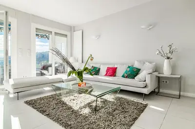 a living room with a couch and a glass table at Luxurious Penthouse with panoramic view in Villefranche-sur-Mer
