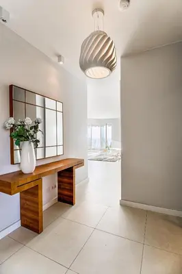 a living room with a table and a vase of flowers at Luxurious Penthouse with panoramic view in Villefranche-sur-Mer