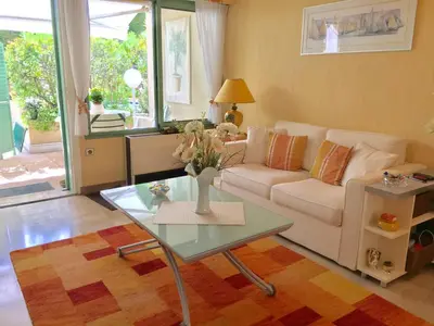a living room with a couch and a table at Studio cosy à Villefranche sur mer in Villefranche-sur-Mer