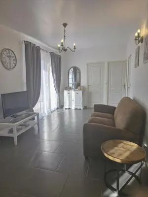 a living room with a couch and a table at La petite maison in La Gaude