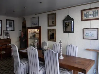 a dining room with a wooden table and chairs at L'Oursin in Saint-Jean-Cap-Ferrat