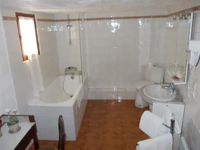 a bathroom with a tub and a toilet and a sink at L'Oursin in Saint-Jean-Cap-Ferrat