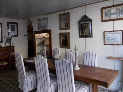 a dining room with a wooden table and chairs at L'Oursin in Saint-Jean-Cap-Ferrat