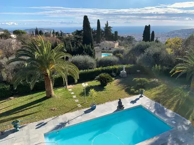 a swimming pool in a garden with a view of the ocean at Diamond Villa 5 Star - NICE in Nice