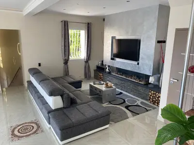 a living room with a couch and a flat screen tv at Diamond Villa 5 Star - NICE in Nice