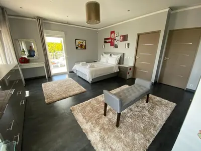a bedroom with a bed and a table and a chair at Diamond Villa 5 Star - NICE in Nice