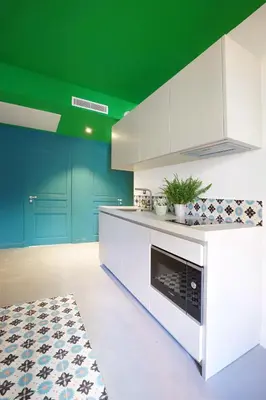 a kitchen with green walls and a white and green ceiling at L'Abeille - Boutique Apartments in Nice