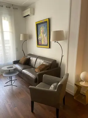 a living room with a couch and a chair at Appartement moderne 4p hypercentre de nice in Nice