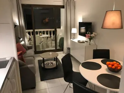 a small living room with a table and a couch at Nice/Villefranche in Villefranche-sur-Mer