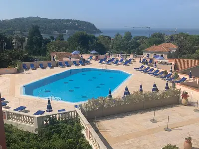 a large swimming pool with lounge chairs at Nice/Villefranche in Villefranche-sur-Mer