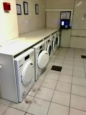 a laundry room with a row of washing machines at Nice/Villefranche in Villefranche-sur-Mer