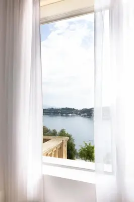 a window with a view of the water at Villa Belvedere in Nice