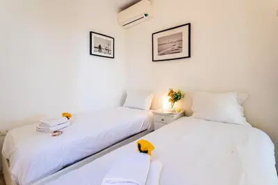 two beds in a room with white walls at HENRIETTA AP4070 - avenue Soleil d'Or - Villefranche-sur-Mer in Villefranche-sur-Mer