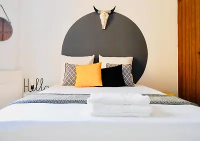 a bedroom with a bed with pillows and a headboard at Nuances d'Azur - Bel Azur in Nice