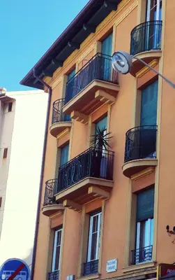 a tall building with balconies and a street light at Nuances d'Azur - Bel Azur in Nice