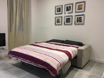 a bed in a bedroom with pictures on the wall at Heart of Nice Harboor cosy and central in Nice