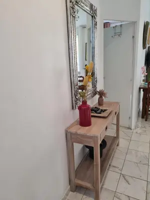 a mirror on a wall next to a wooden table at la palais osiris Nice centre jardin wifi clim parking in Nice