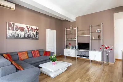 a living room with a couch and a table at Le Blacas in Nice