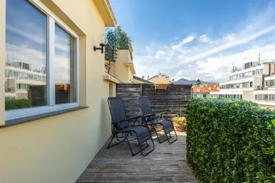 a patio with two chairs and a window at Le Blacas in Nice