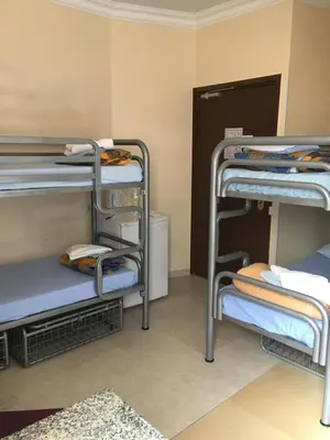 a room with three bunk beds in a room at Antares hostel in Nice