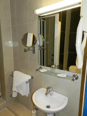 a bathroom with a sink and a mirror at Antares hostel in Nice