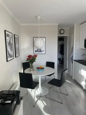 a kitchen and dining room with a table and chairs at Nyrenoverad lägenhet med havsutsikt in Villefranche-sur-Mer