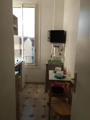 a small kitchen with a table and a window at Nice Centre, Charmant Studio in Nice