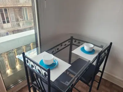 a table with two chairs and two cups on them at Nice Centre, Charmant Studio in Nice