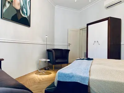 a bedroom with a bed and a chair and a mirror at Villa Bagatelle - Luxury apartment in Nice