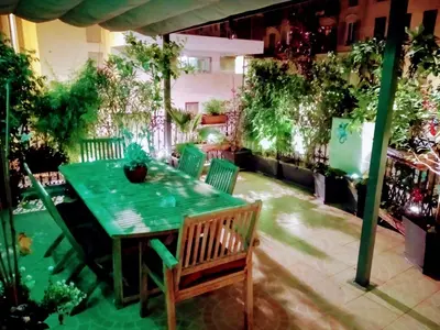 a green table and chairs on a patio at la terrasse in Nice
