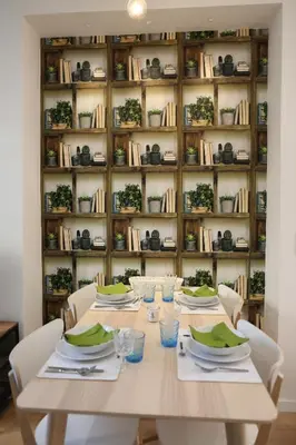 a table with white chairs and a book shelf at la terrasse in Nice