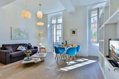 a living room with a couch and a table and chairs at MY CASA - LIBERTÉ - Spacious Apartment City Center w AC in Nice