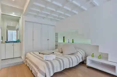 a white bedroom with a bed in a room at MY CASA - LIBERTÉ - Spacious Apartment City Center w AC in Nice