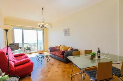 a living room with a red couch and a table at LE FLORIDE AP4156 Nice, by Riviera Holiday Homes in Nice