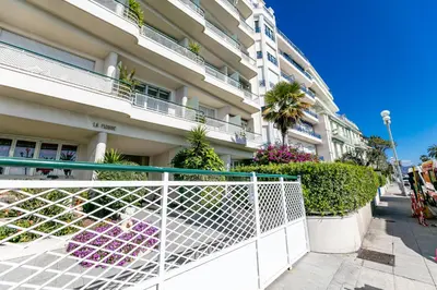 a white fence in front of a building at LE FLORIDE AP4156 Nice, by Riviera Holiday Homes in Nice