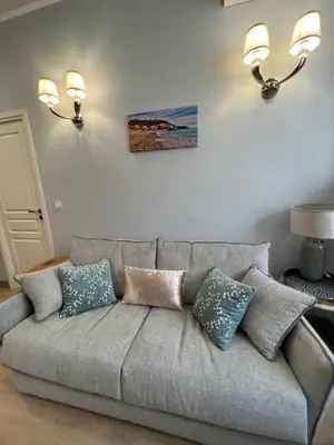 a couch with pillows on it in a living room at D’AZUR-35 in Nice