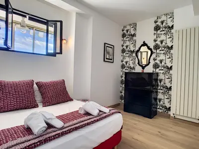 a bedroom with a bed with two towels on it at Nestor&Jeeves - TOUCAN DUPLEX TERRACE - Hyper center - Top floor in Nice