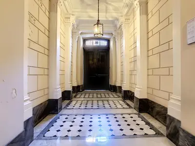 a hallway with a black door and a tiled floor at Nestor&Jeeves - TOUCAN DUPLEX TERRACE - Hyper center - Top floor in Nice