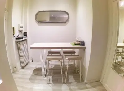 a small kitchen with a table and stools at Apartment in the heart of Nice in Nice