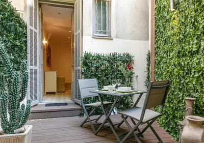 a table and chairs on a patio with plants at Apartment in the heart of Nice in Nice