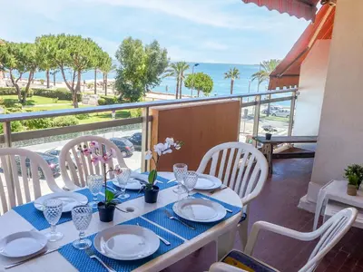 a living room with a couch and a table at Apartment La Pinède-1 by Interhome in Cagnes-sur-Mer