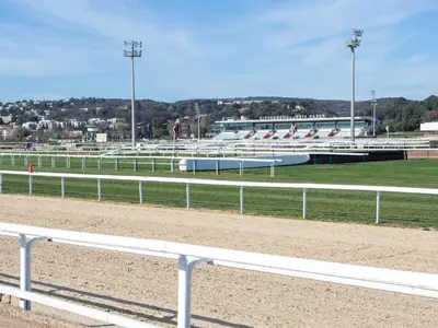 a race track with white rails and a race track at Apartment La Pinède-2 by Interhome in Le Puits
