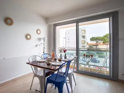 a living room with a blue couch and a table at Apartment La Pinède-2 by Interhome in Le Puits