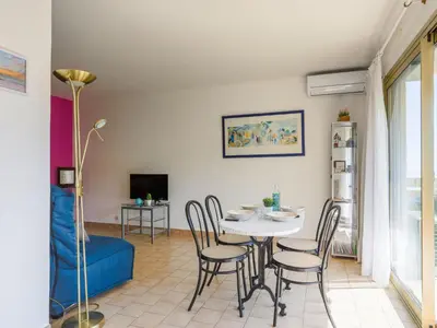 a kitchen with white cabinets and a sink at Apartment Domaine du Clairfontaine by Interhome in Nice