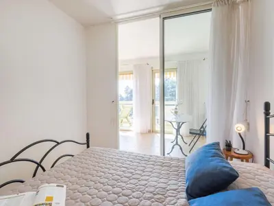 a dining room with a table and chairs and a balcony at Apartment Domaine du Clairfontaine by Interhome in Nice