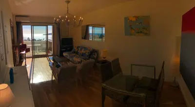 a living room with a couch and a table at **** Panoramic Top Roof in Beaulieu **** in Beaulieu-sur-Mer